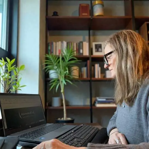 Business Management Support Person at Laptop